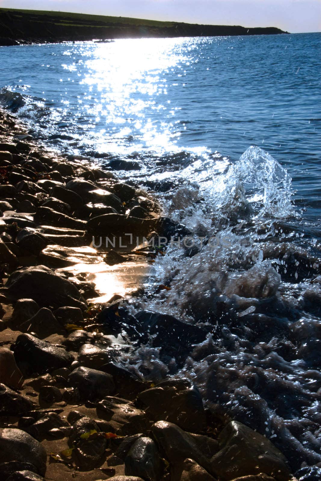 some rocks being washed over by the waves