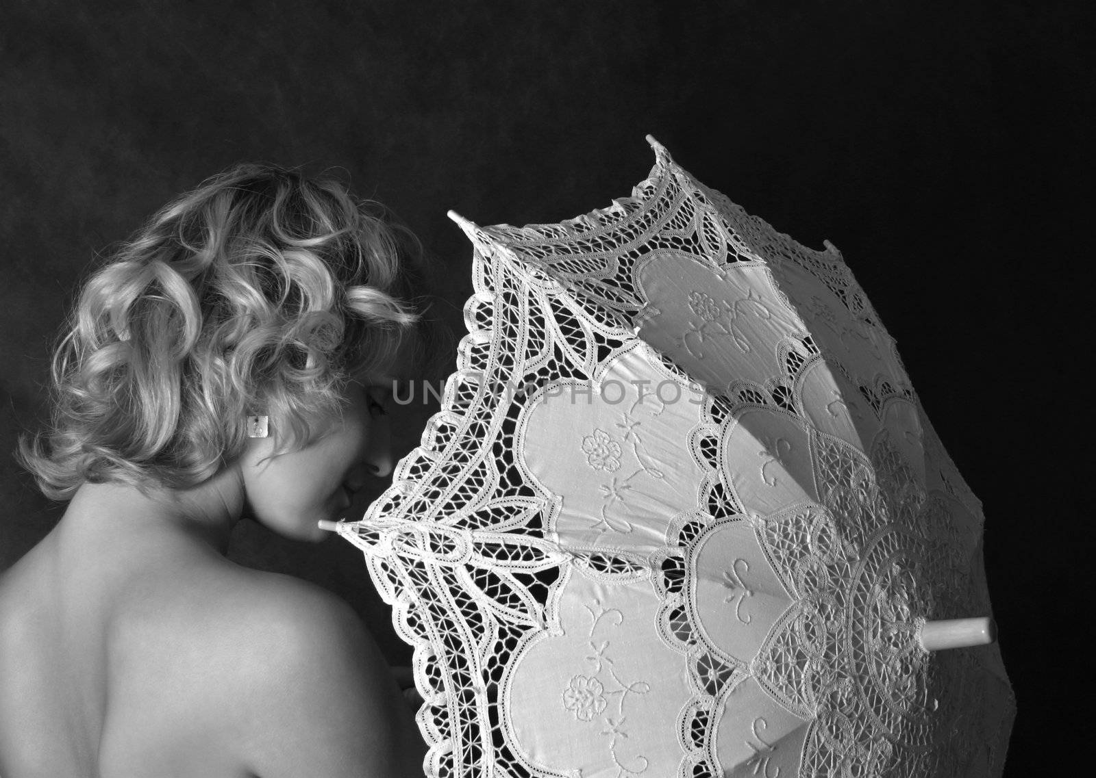 The beautiful woman with a lacy umbrella