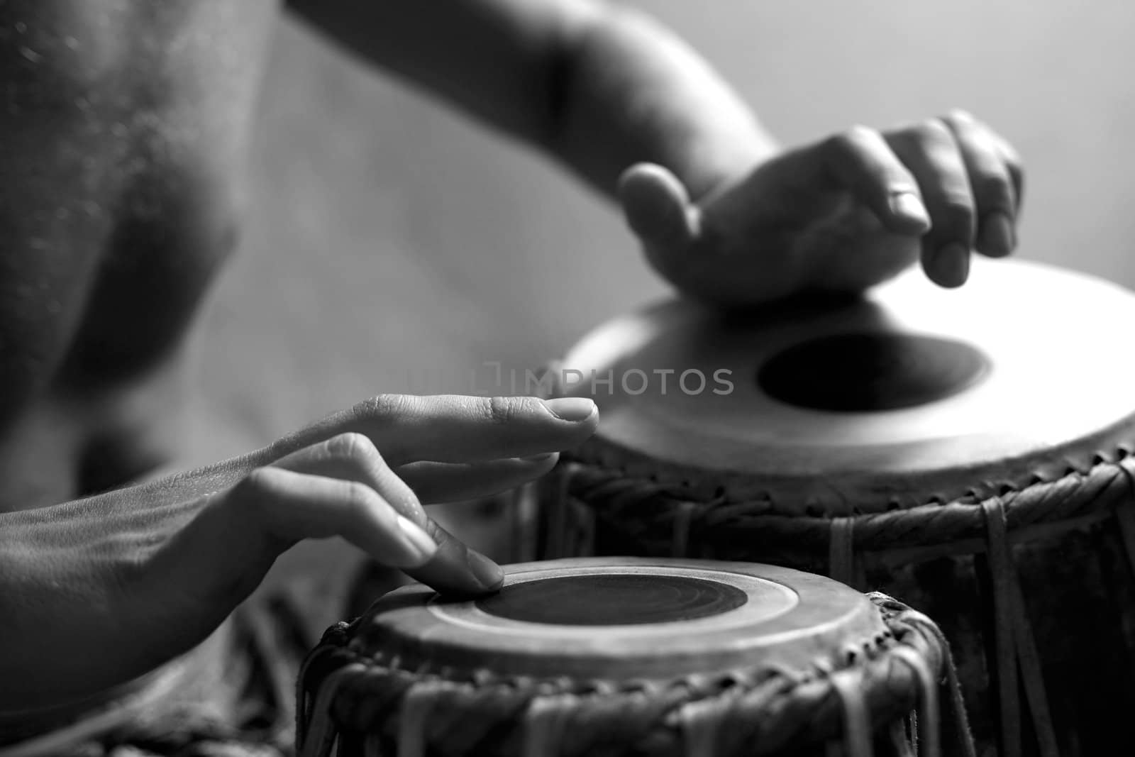 Man playing the djembe (nigerian drum) in studio