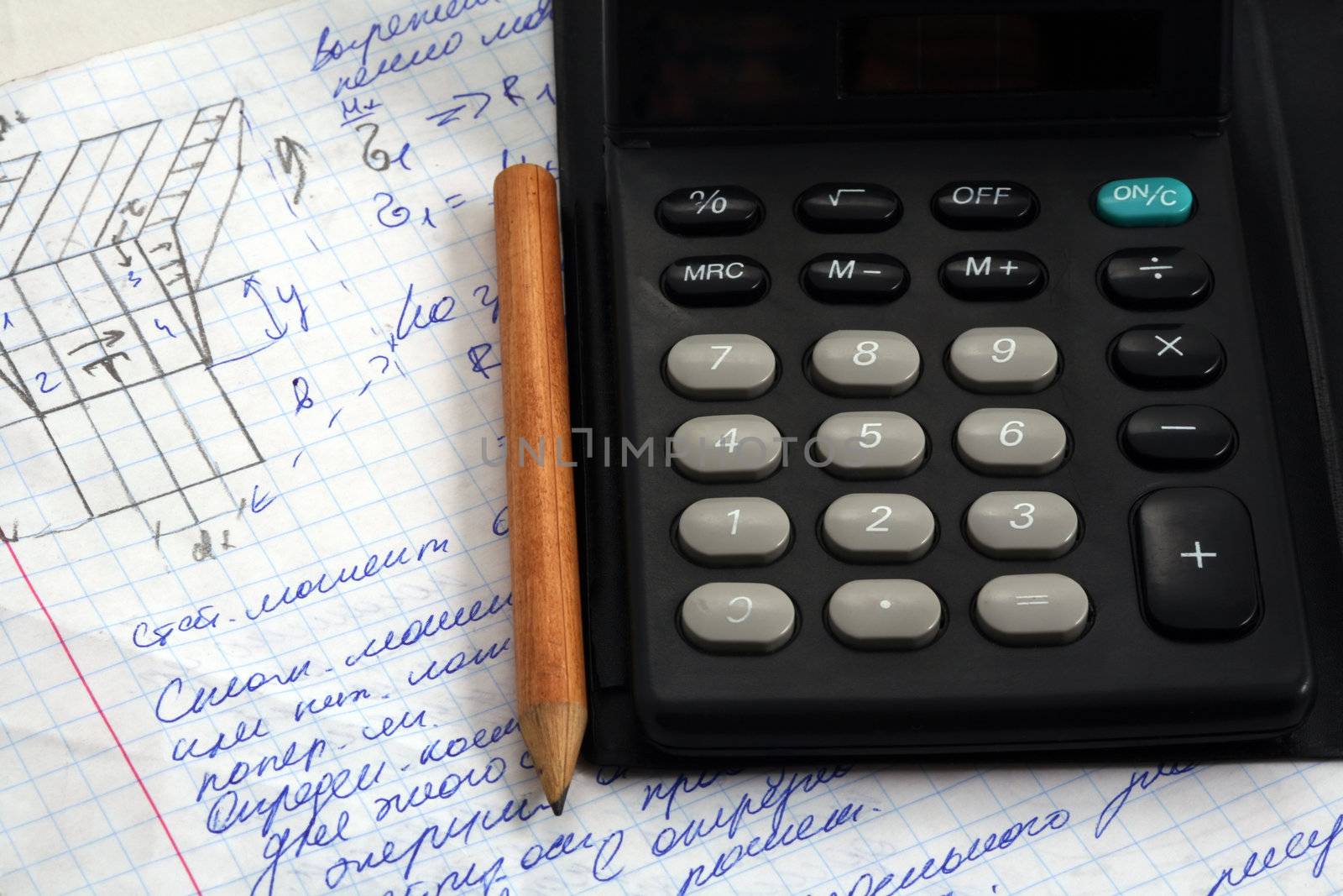 Calculator, pen and a piece of paper after home work.