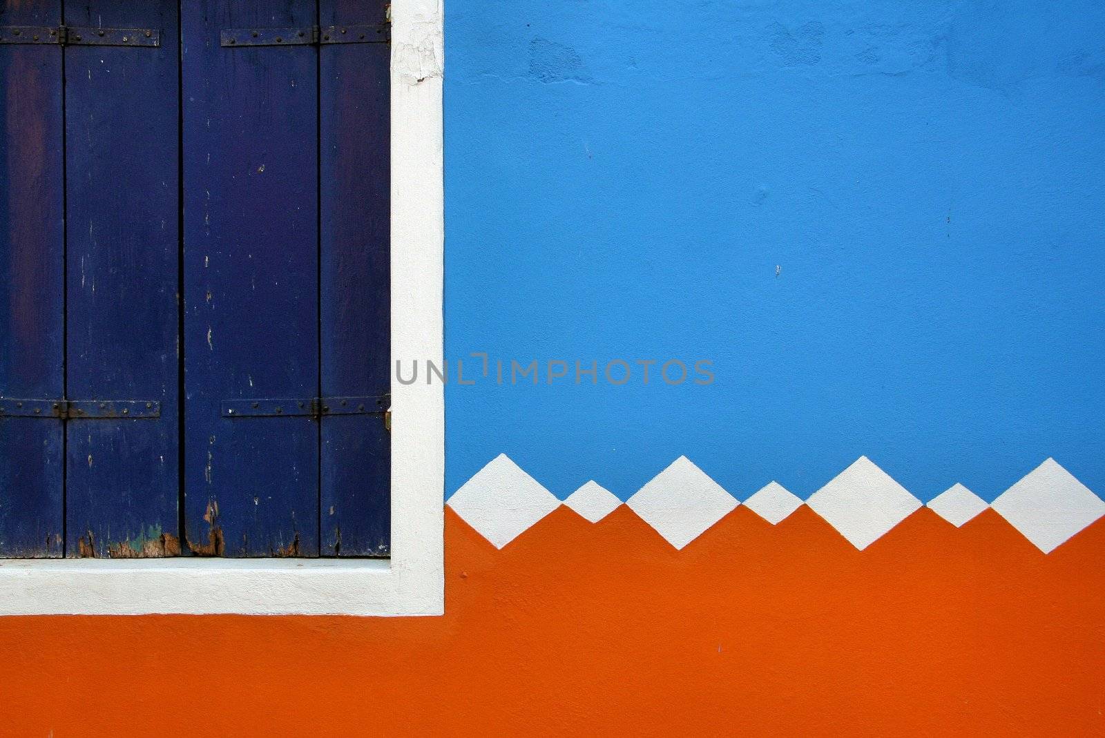 Part of colored wall and wooden shutter, photo taken in Burano (Venice)