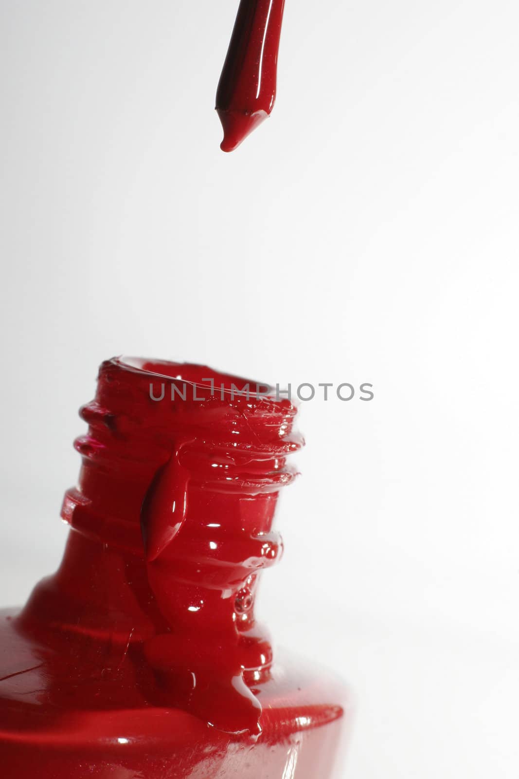 The image of a brush with a red paint