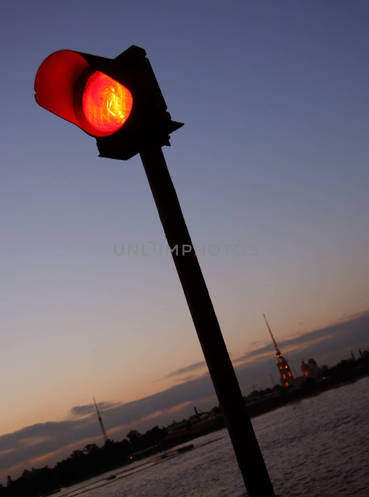 Navigation is prohibited. Closeup of red traffic light on the Palace Bridge with the Peter and Paul Fortress in the background. Saint-Petersburg, Russia