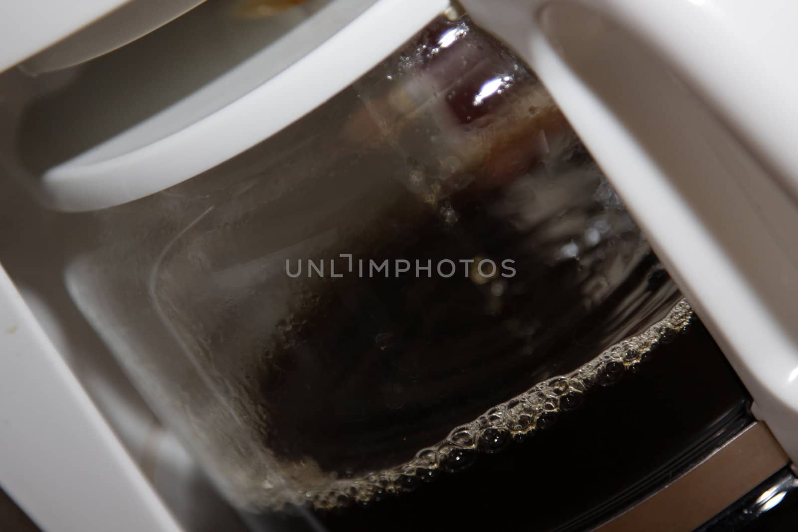 A close-up of coffee brewer, brewing the morning coffee.