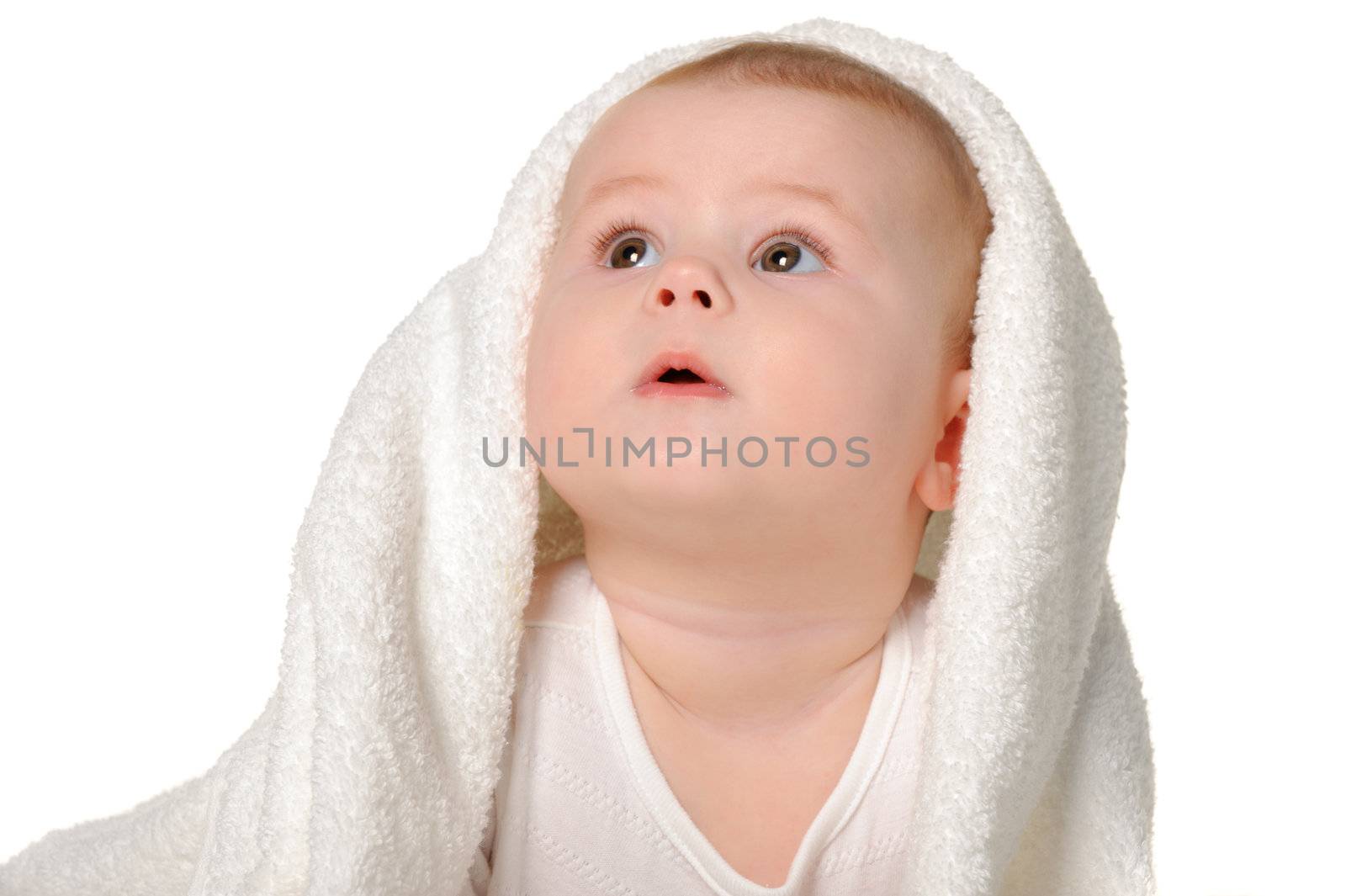 The baby under a towel. Age of 8 months. It is isolated on a white background