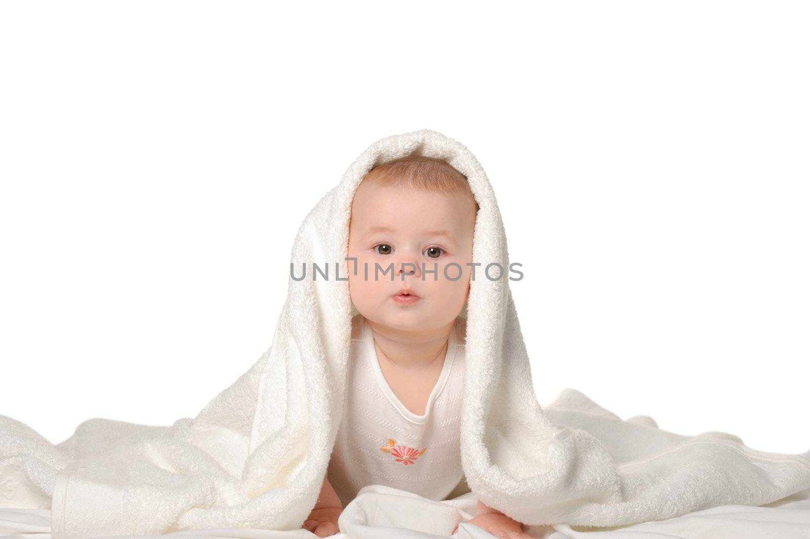 The baby under a towel. Age of 8 months. It is isolated on a white background