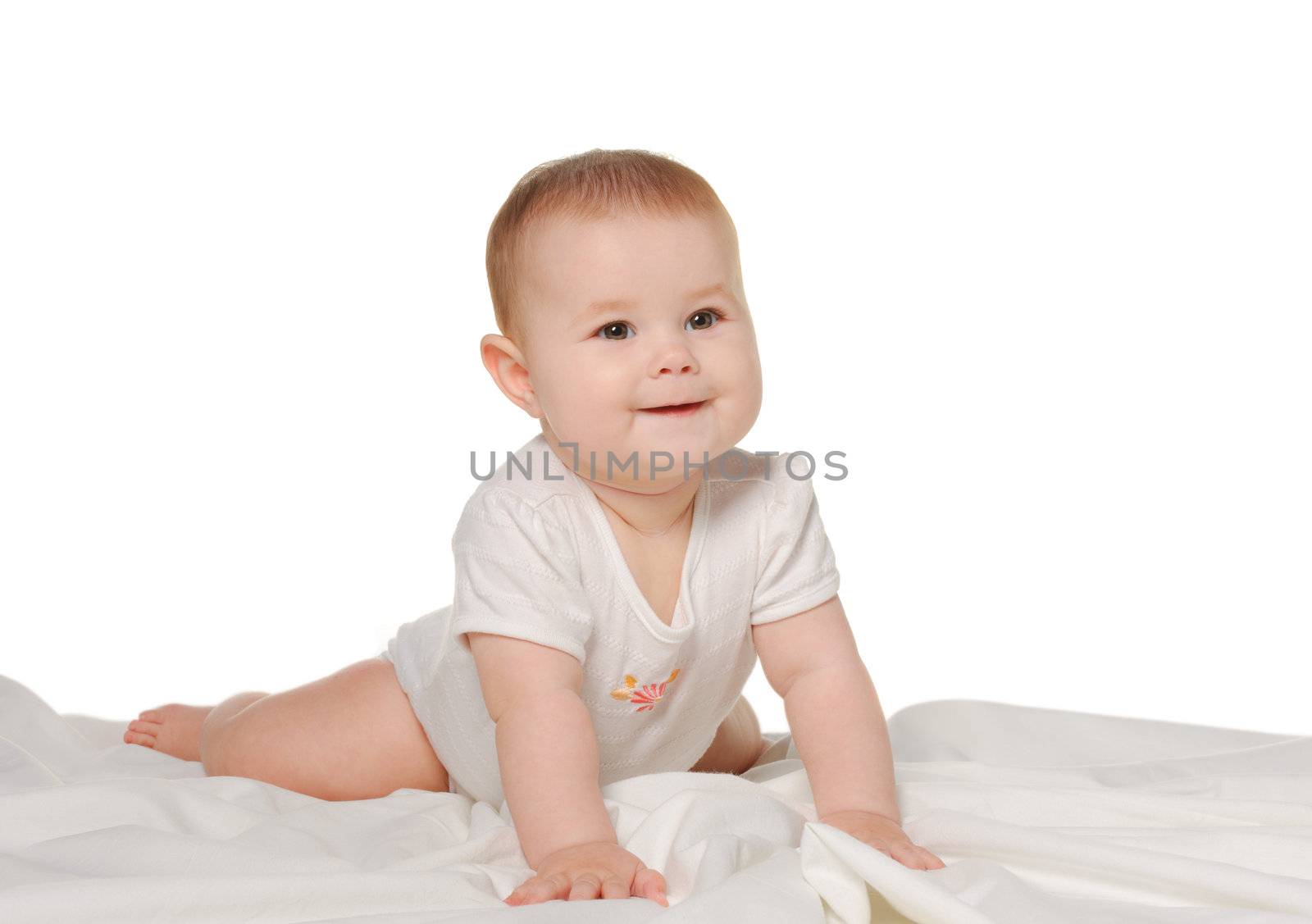 The baby on a bedsheet. Age of 8 months. It is isolated on a white background