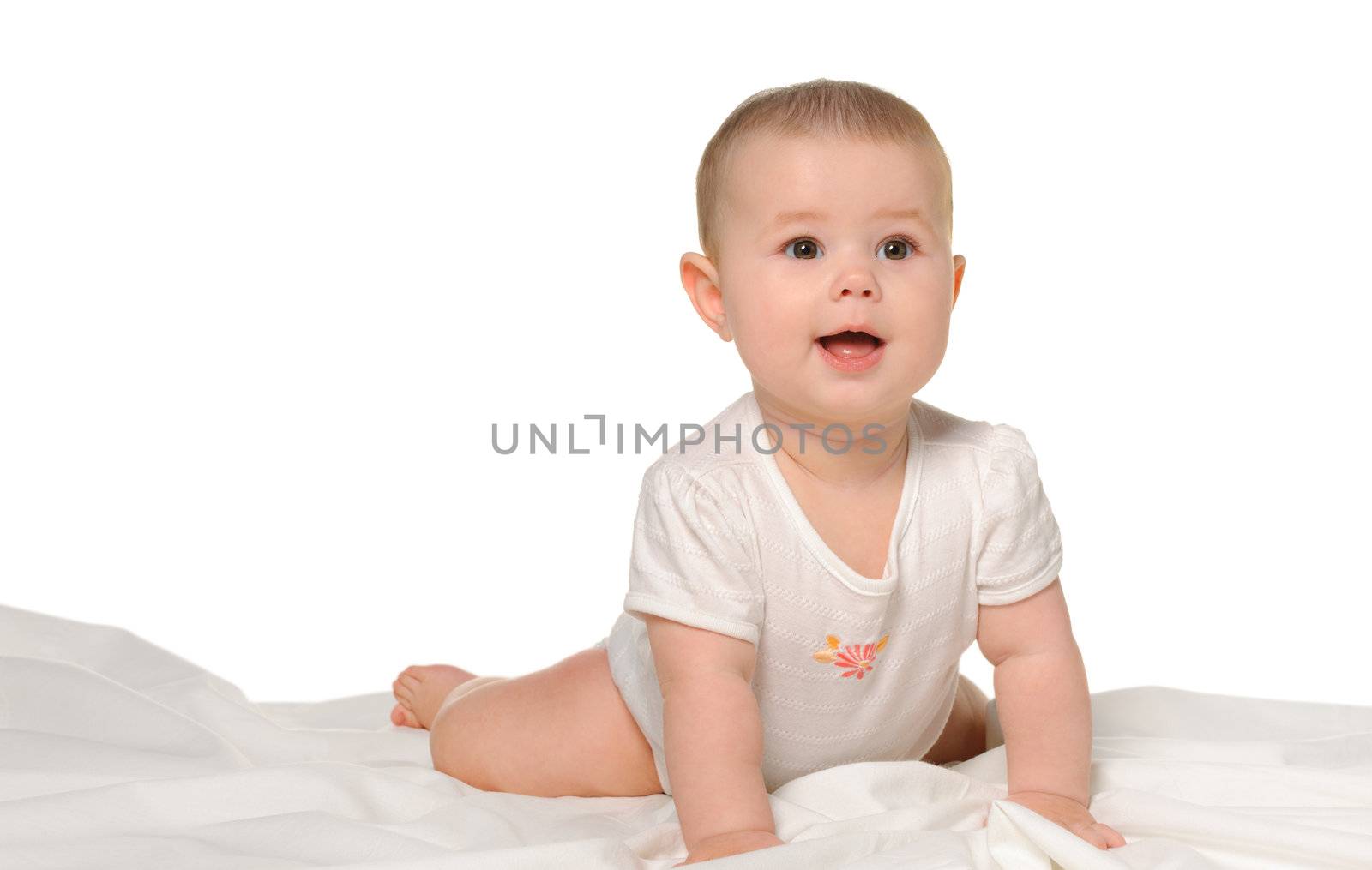 The baby on a bedsheet. Age of 8 months. It is isolated on a white background