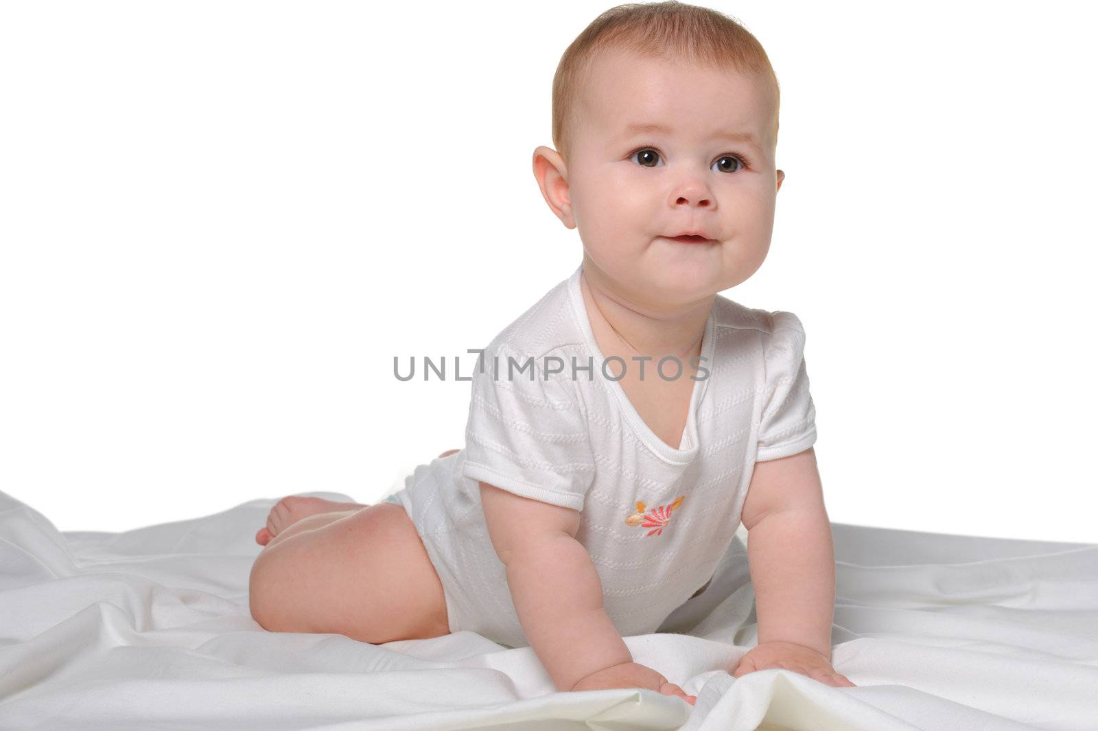 The baby on a bedsheet. Age of 8 months. It is isolated on a white background