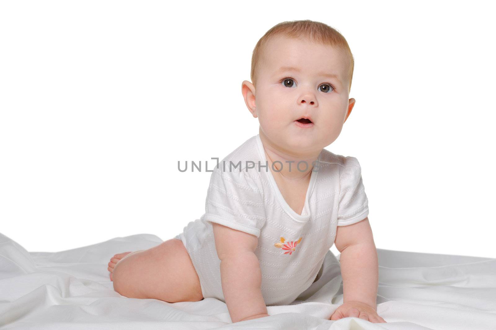 The baby on a bedsheet. Age of 8 months. It is isolated on a white background