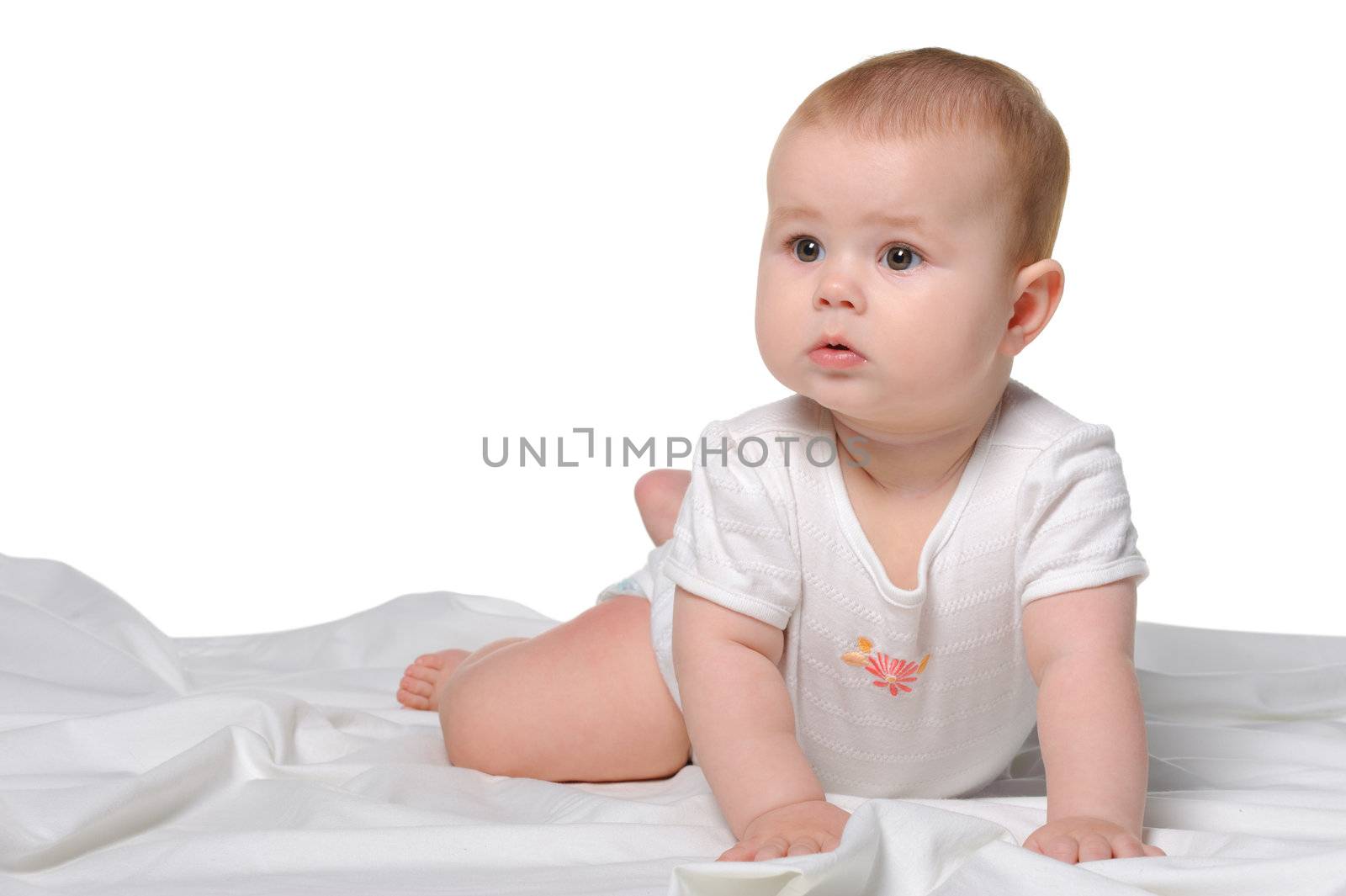 The baby on a bedsheet. Age of 8 months. It is isolated on a white background