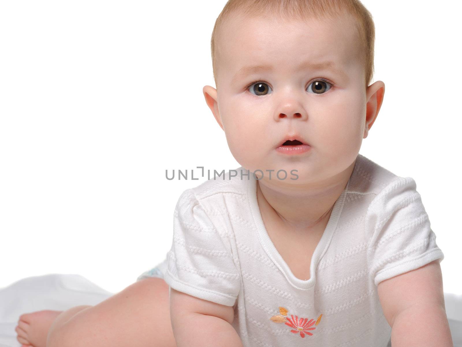 The baby on a bedsheet. Age of 8 months. It is isolated on a white background