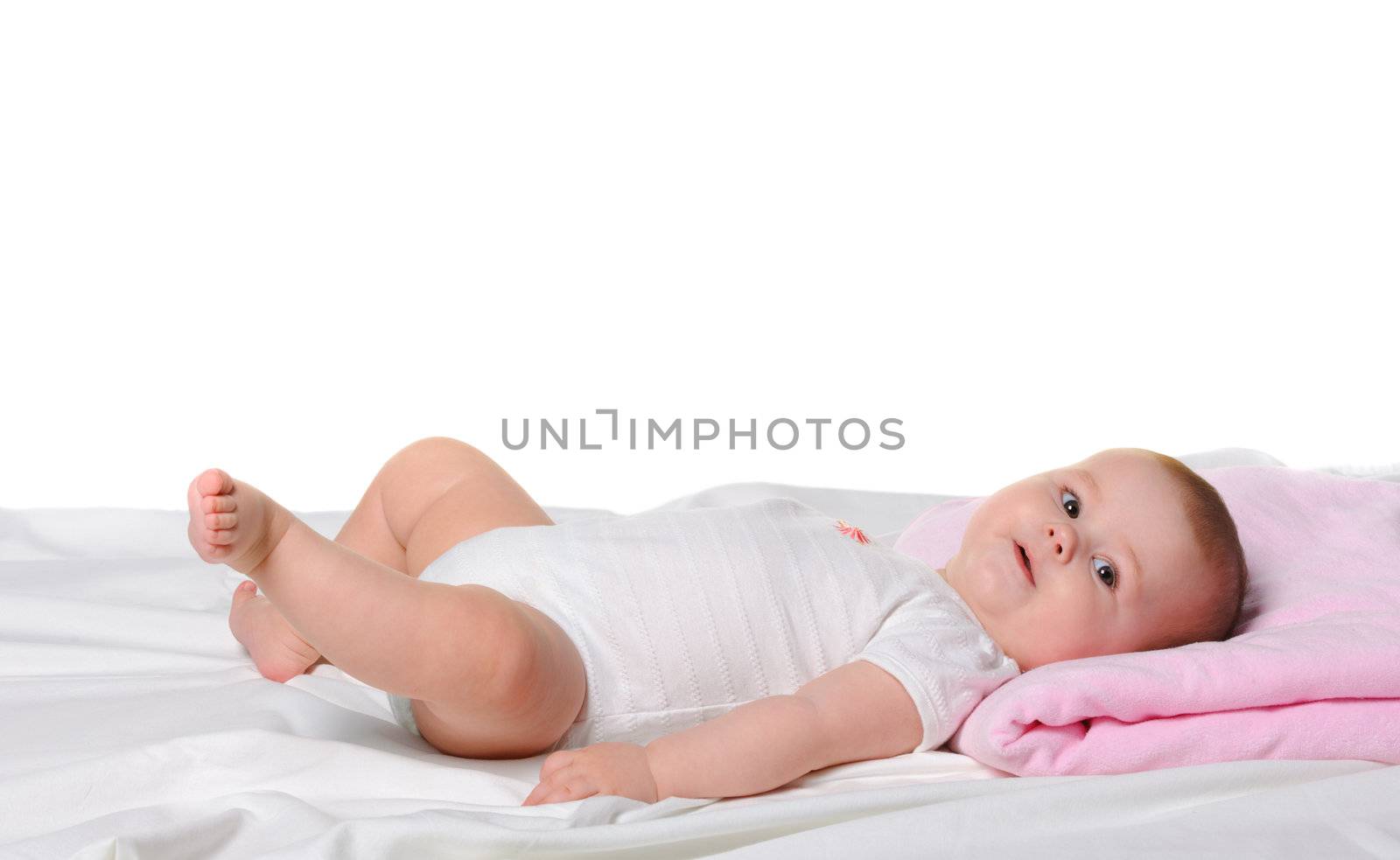 The baby lays. Age of 8 months. It is isolated on a white background