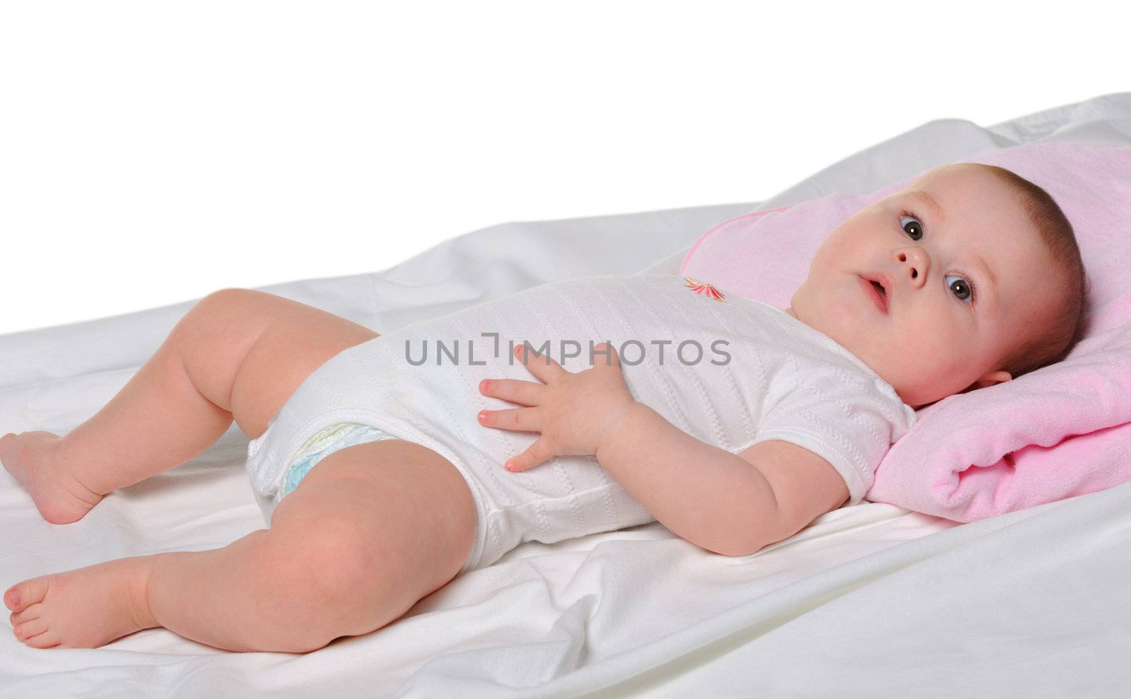 The baby lays. Age of 8 months. It is isolated on a white background