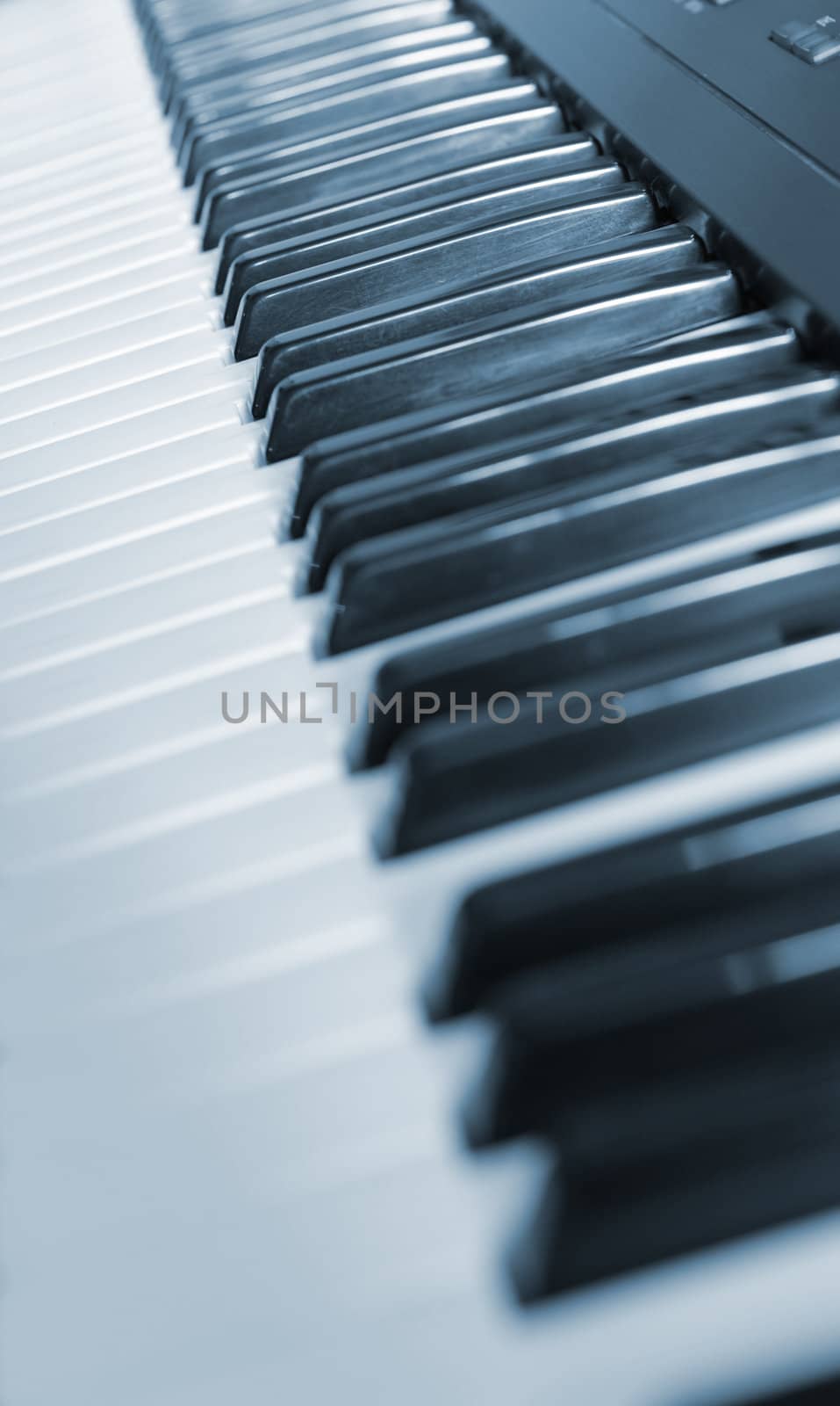 Keys of the piano. A photo close up. Blue tone.