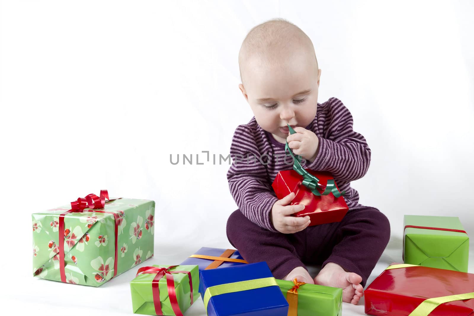 young child unpacking presents. white background