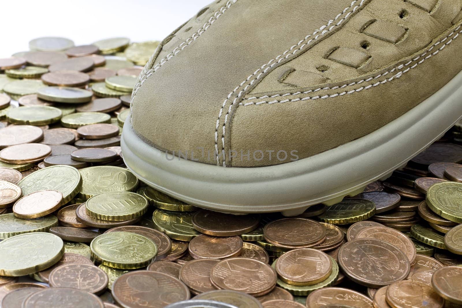light brown leather shoe walking on euro coins