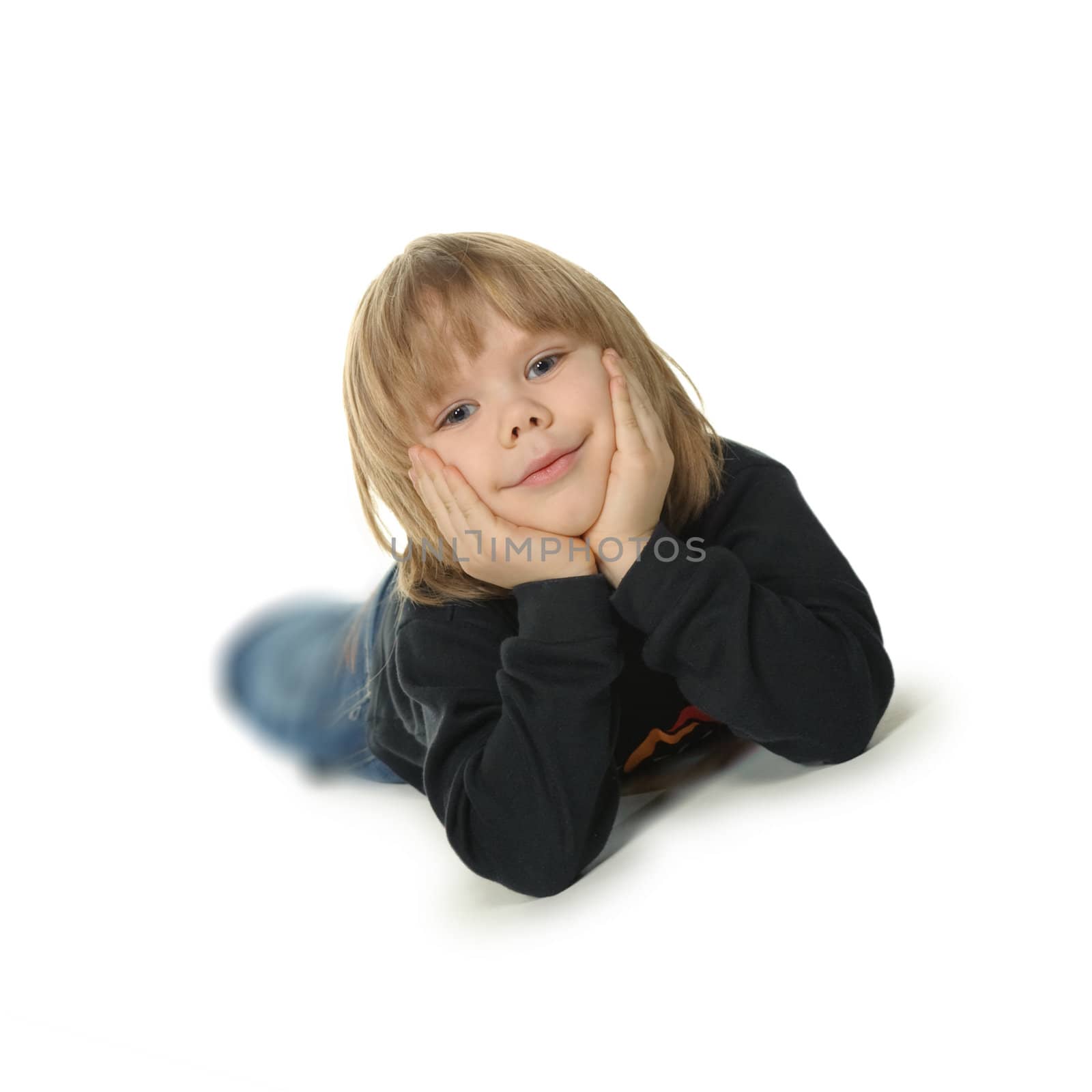 The little boy lays on a floor. It is isolated on a white background