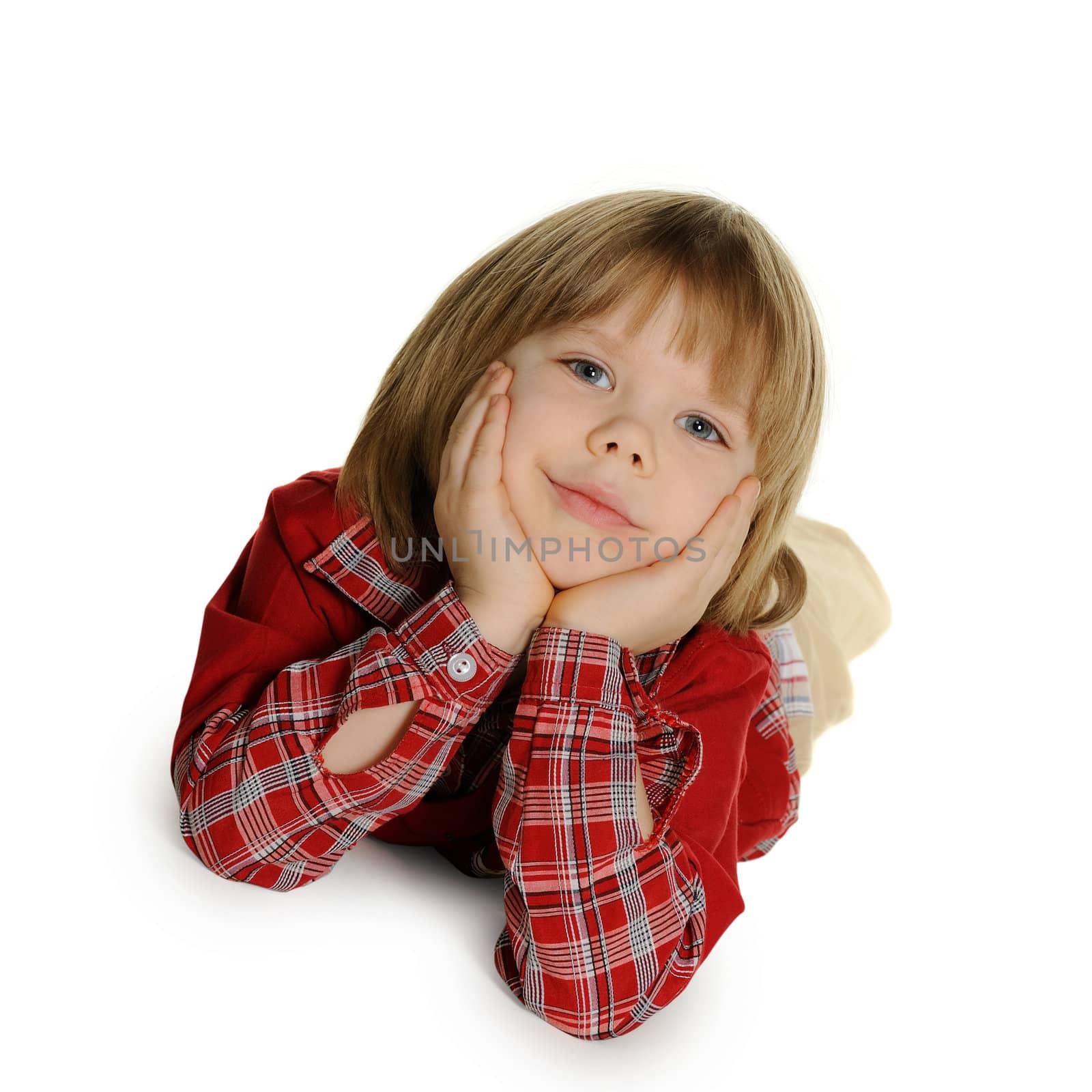 The little boy lays on a floor. It is isolated on a white background