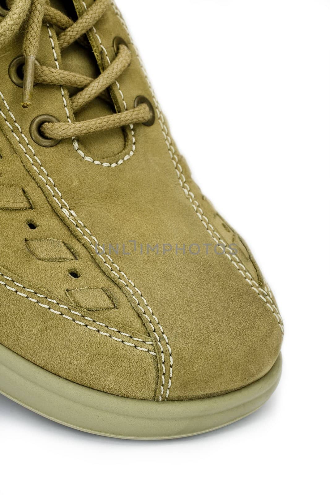 front of brown leather shoe in close up shot on white background
