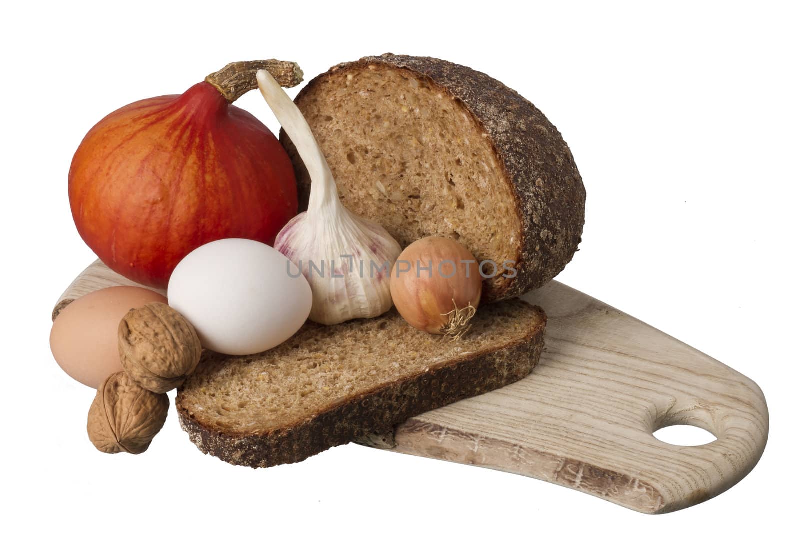 brown bread on shelf with onion, garlic, eggs and walnut  isolated on white background