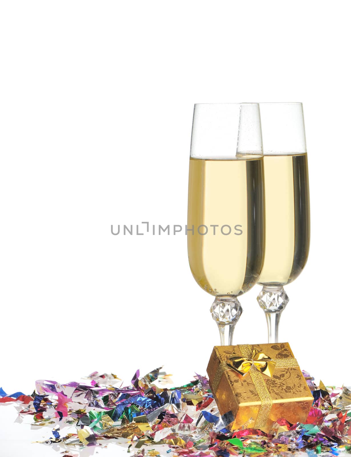 Glasses of a champagne. A celebratory tinsel and a box with a gift