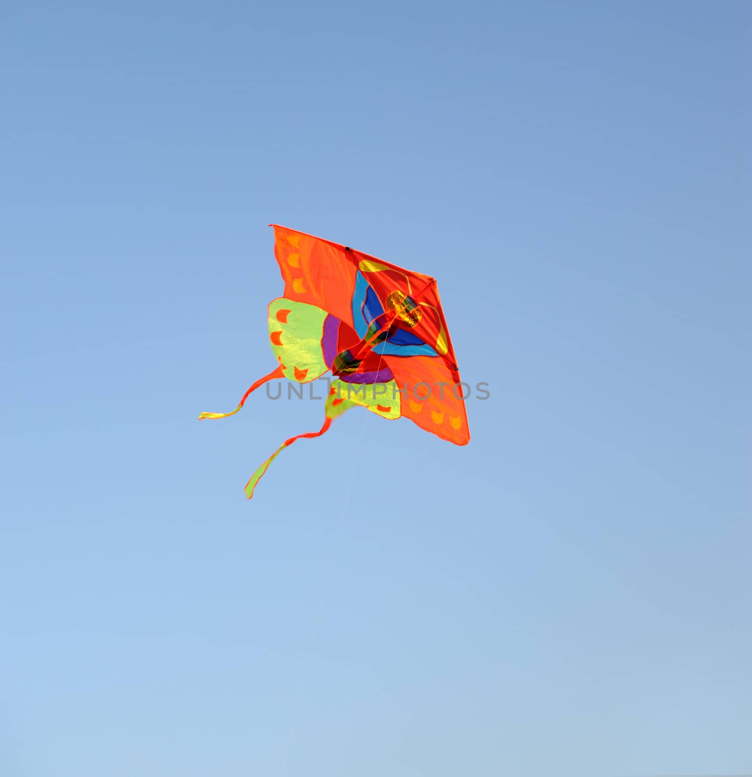 Kite. A colourful kite flying to the dark blue sky