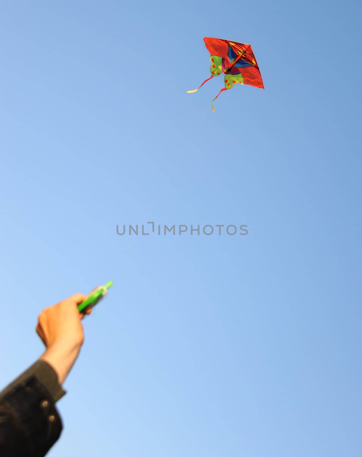 Kite. A colourful kite flying to the dark blue sky