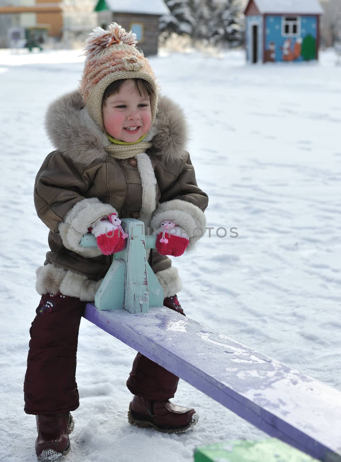 The girl on a swing. Winter, solar frosty weather