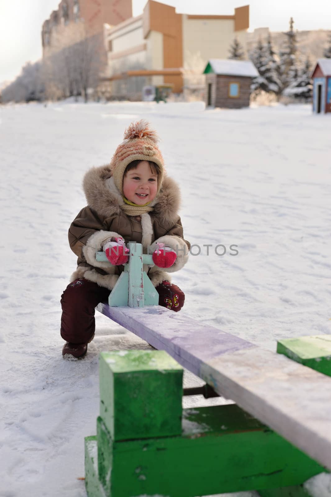 The girl on a swing. Winter, solar frosty weather