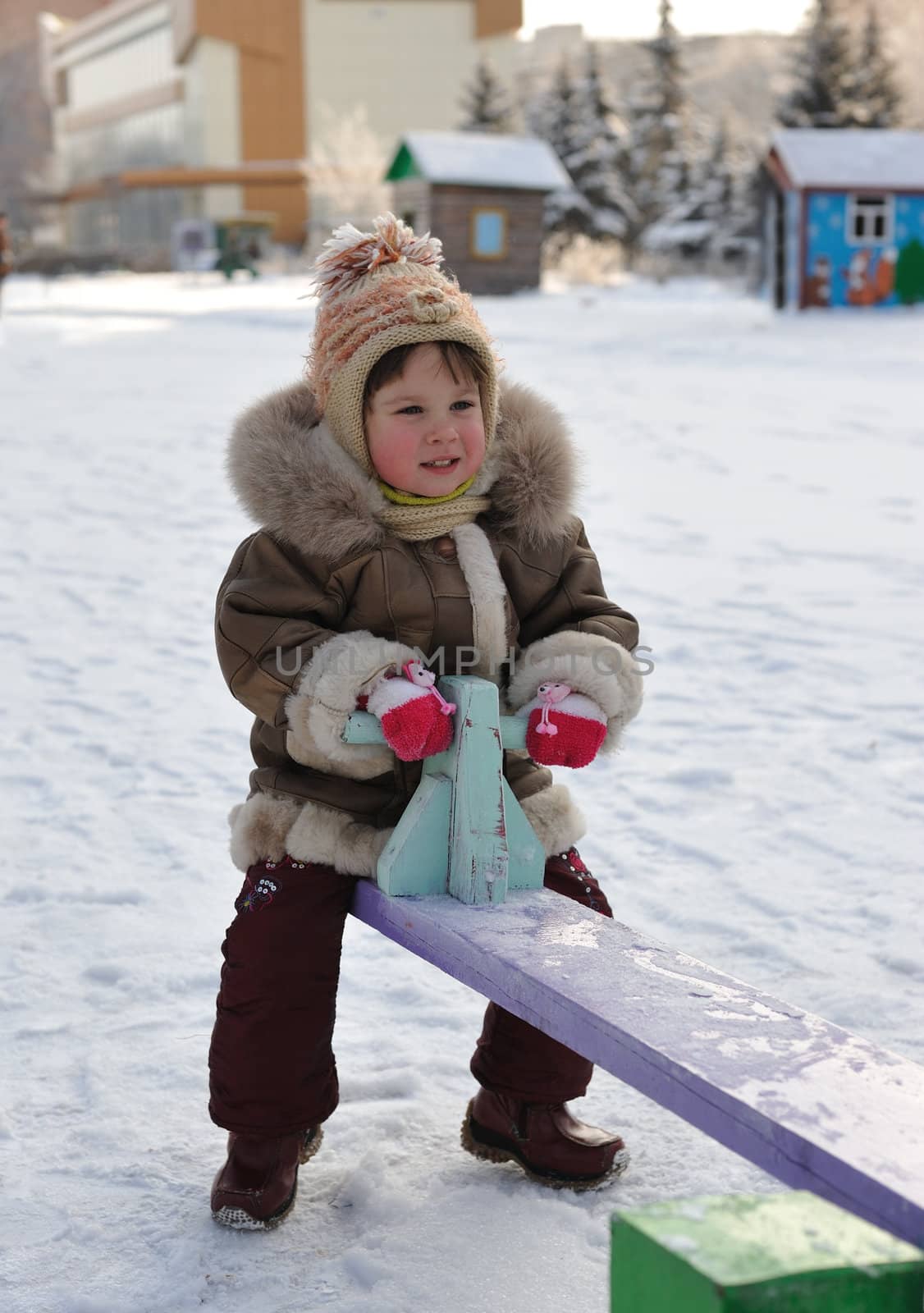 The girl on a swing. Winter, solar frosty weather