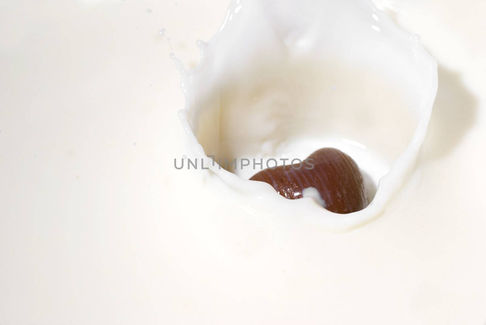 Chocolate heart and milk. Splash in a falling sweet in milk