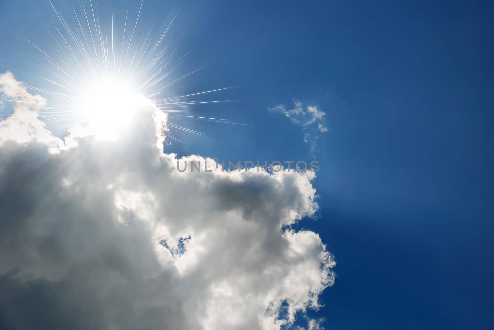 The sun and cloud. Bright beams of the sun because of a cloud. 