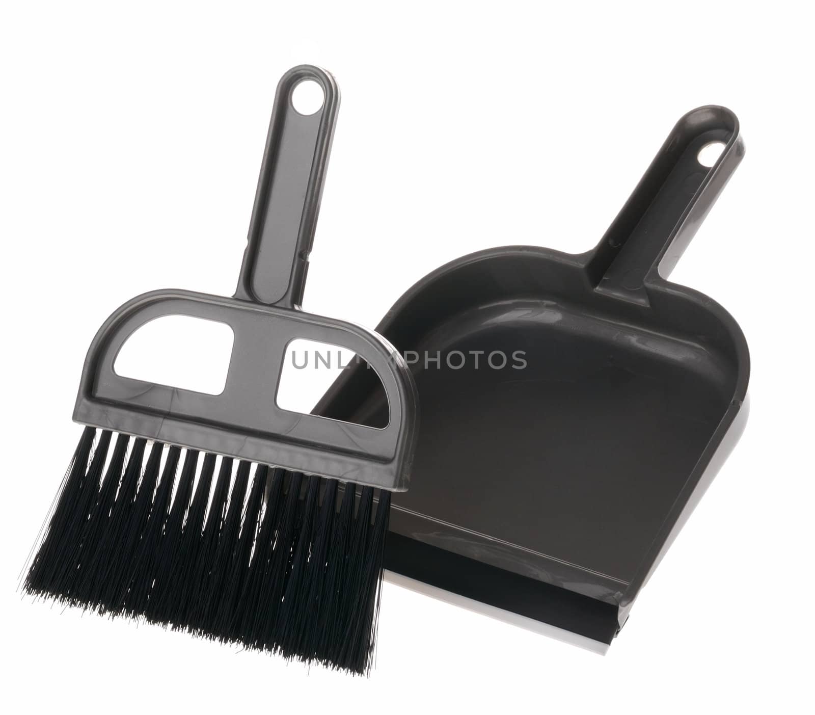 Brush and dustpan. The tool for cleaning it is isolated on a white background