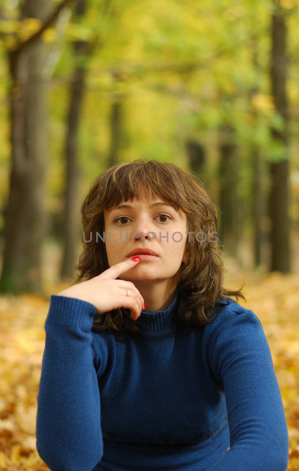 The girl on a background autumn forest. Age - 26 years