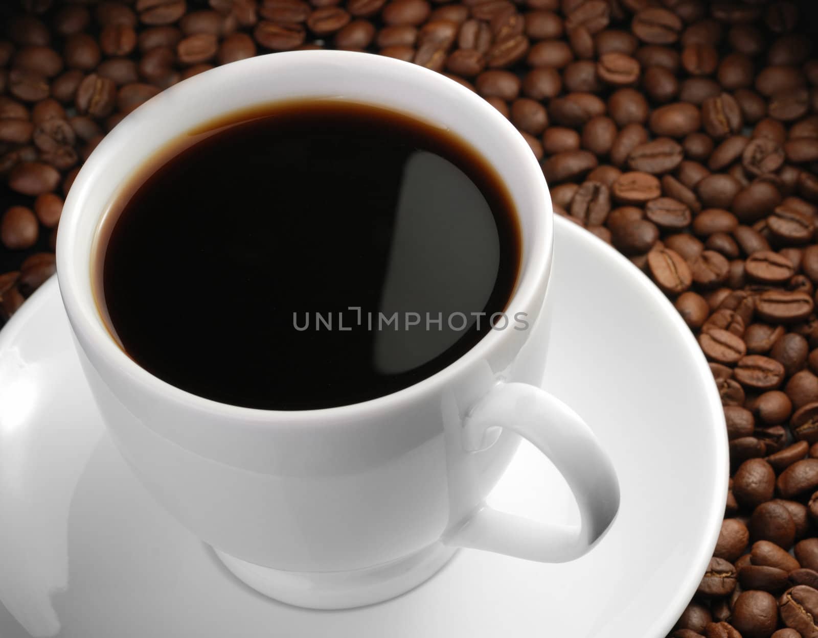 Cup of coffee. A background with coffee grains and a white cup. A photo close up 