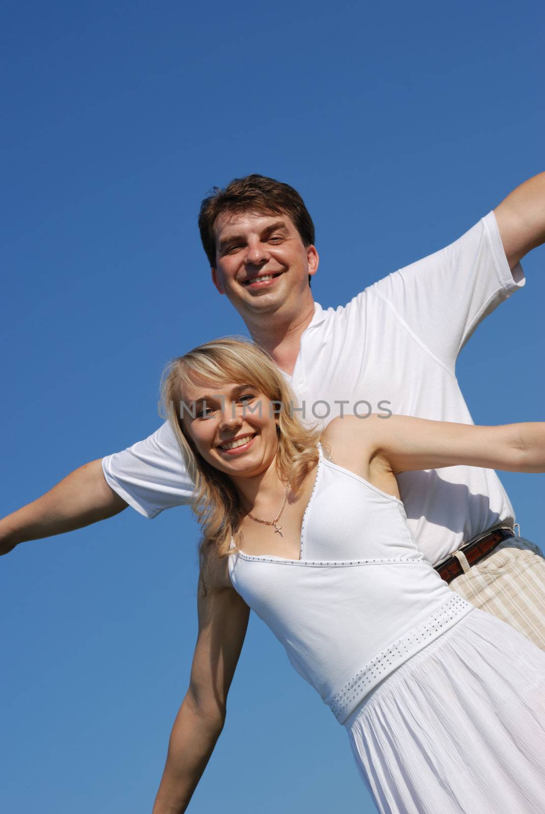 Pair enamoured. Happy family on a background of the blue sky