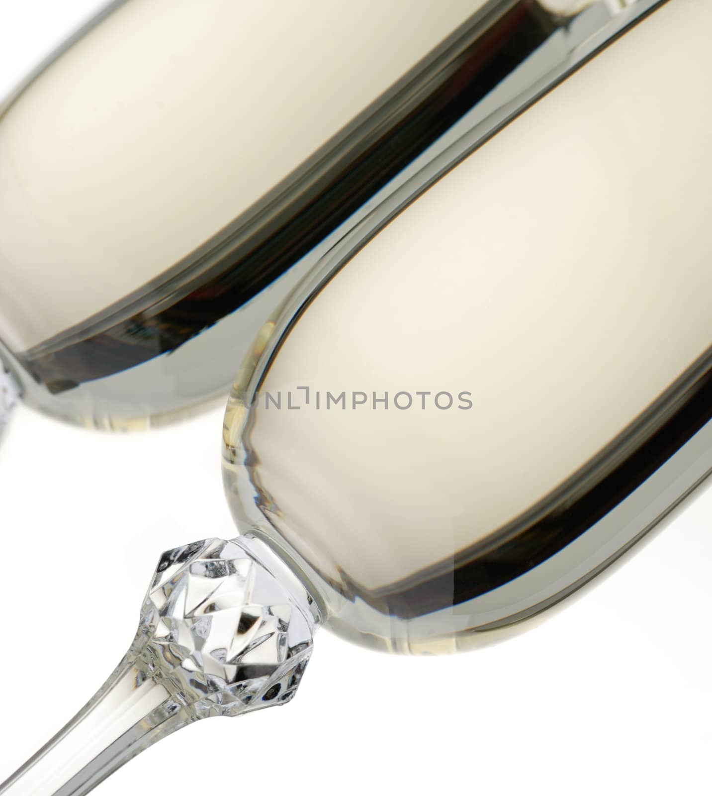 Wine glass with a champagne. A photo on a gleam, it is isolated on a white background