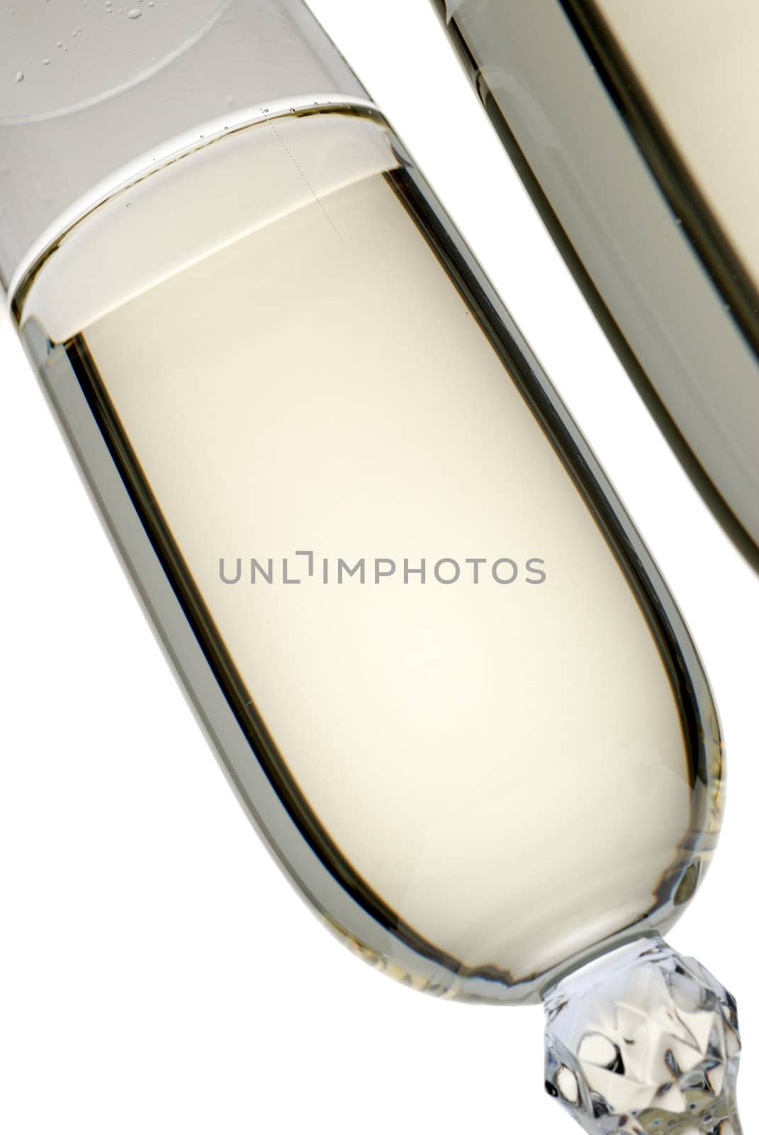 Wine glass with a champagne. A photo on a gleam, it is isolated on a white background