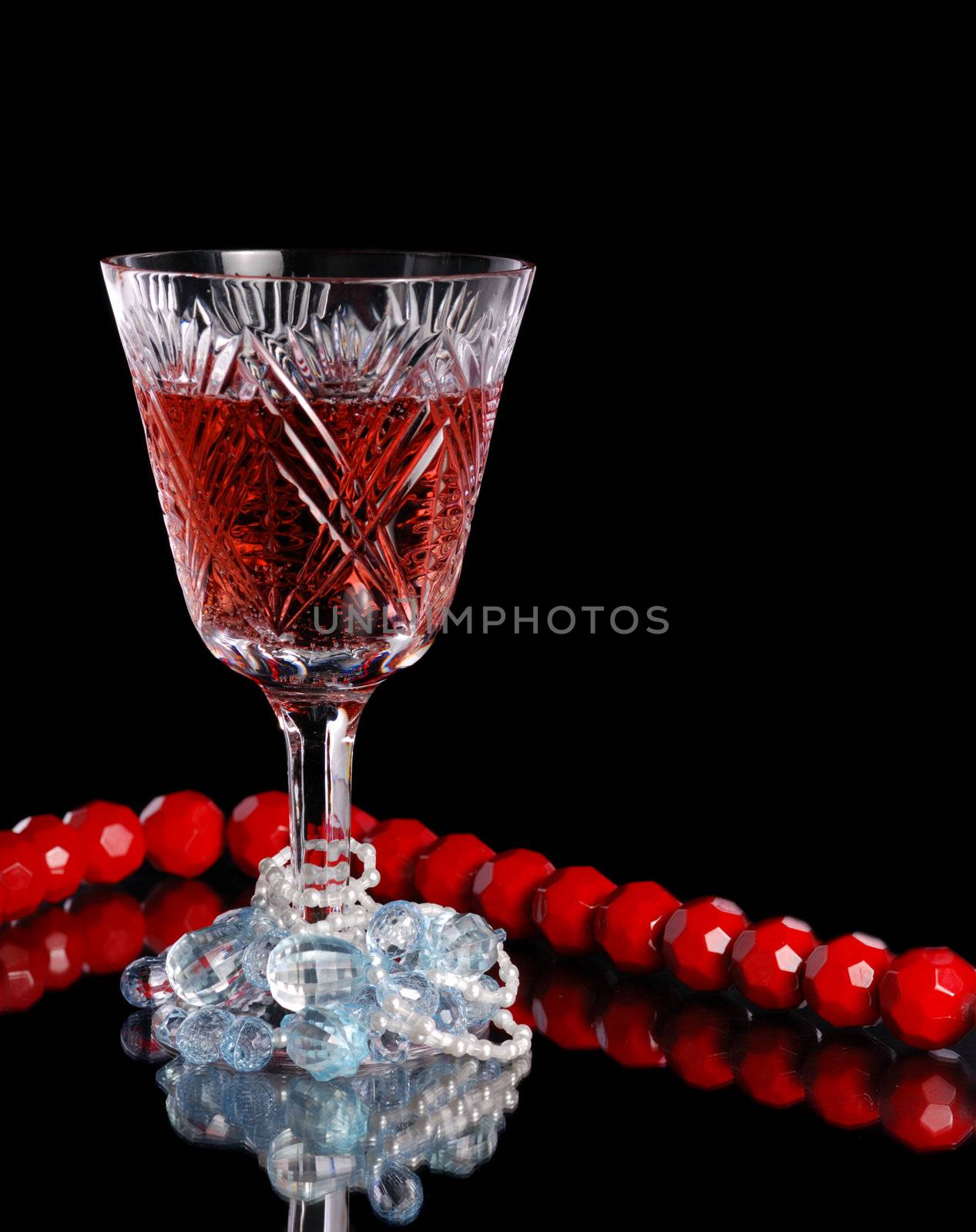 Wine. A glass vessel with wine, a red grape drink