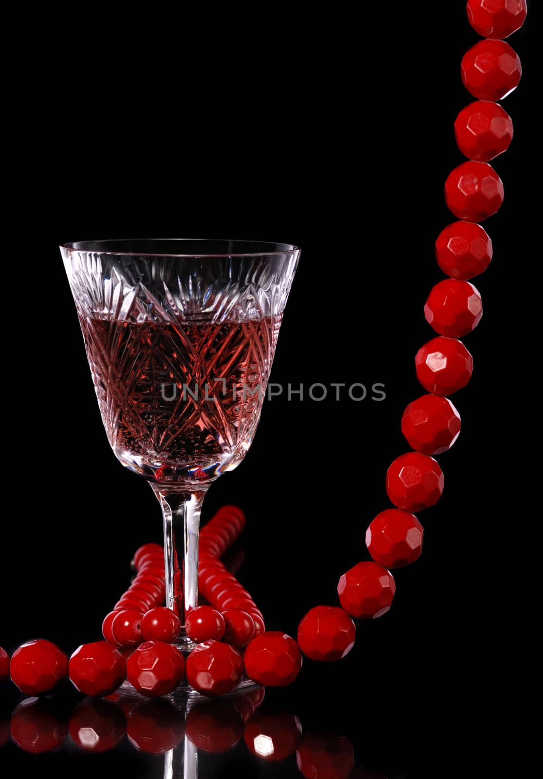 Wine. A glass vessel with wine, a red grape drink