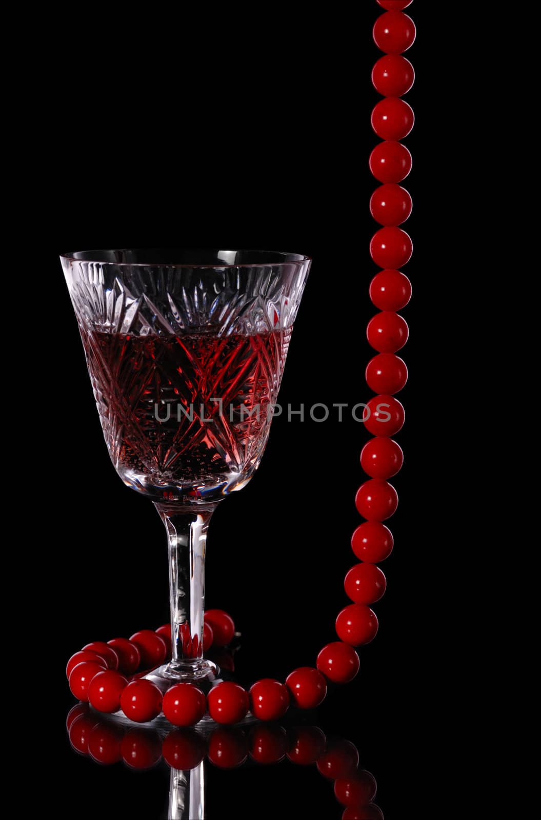 Wine. A glass vessel with wine, a red grape drink