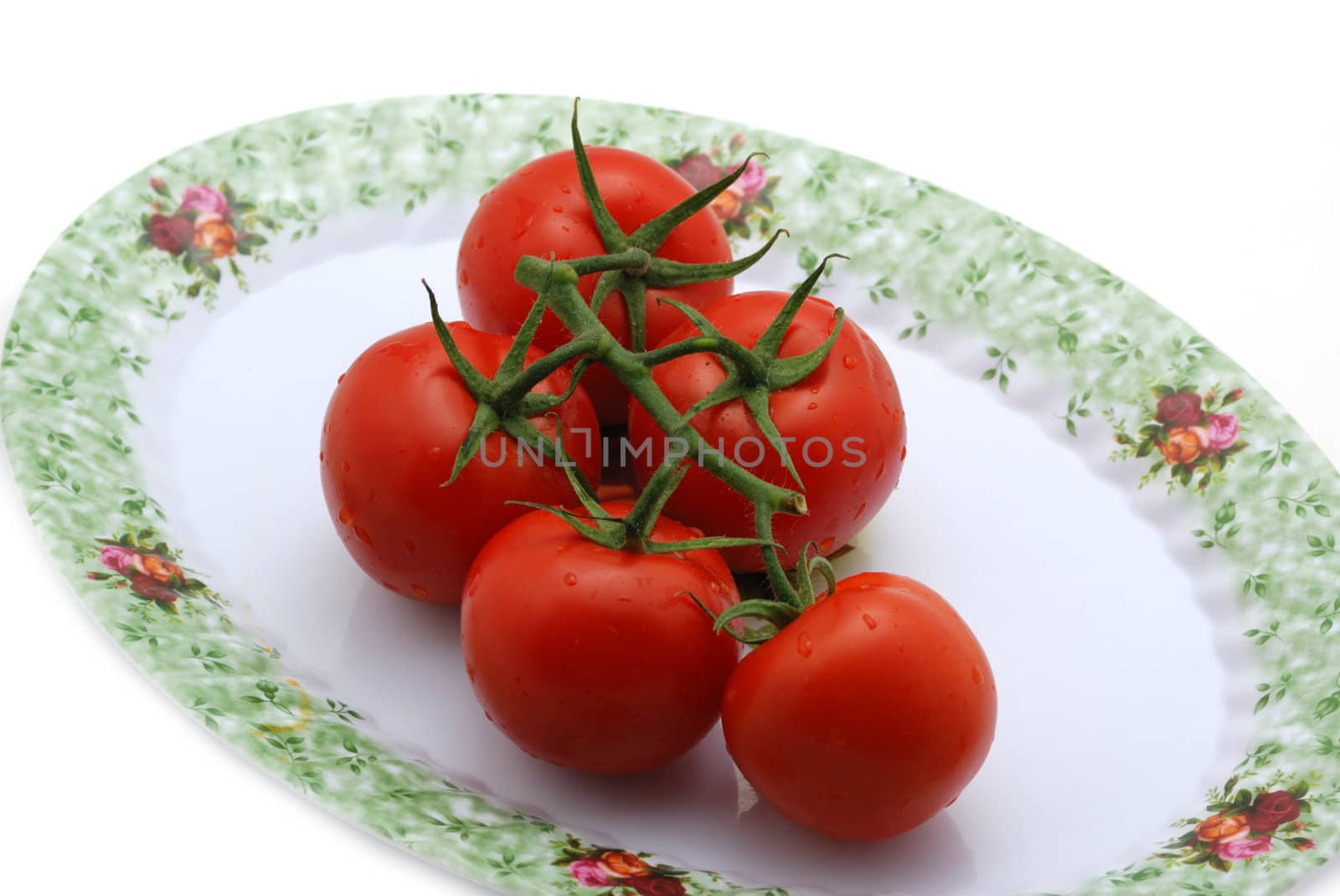 Tomato. It is isolated on a white background. A ripe vegetable.