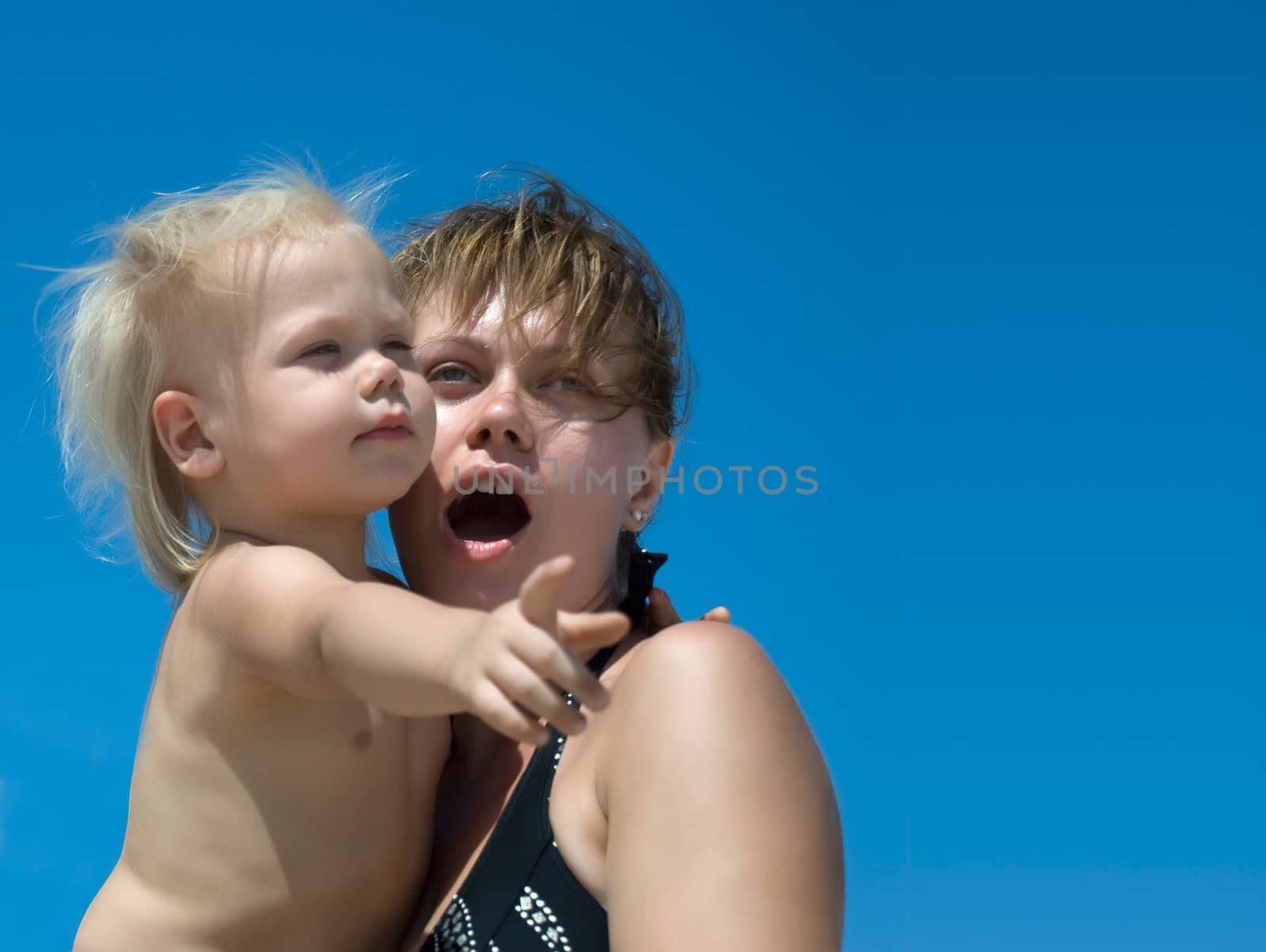 Mother with the child. Emotionally surprised woman and the passive child