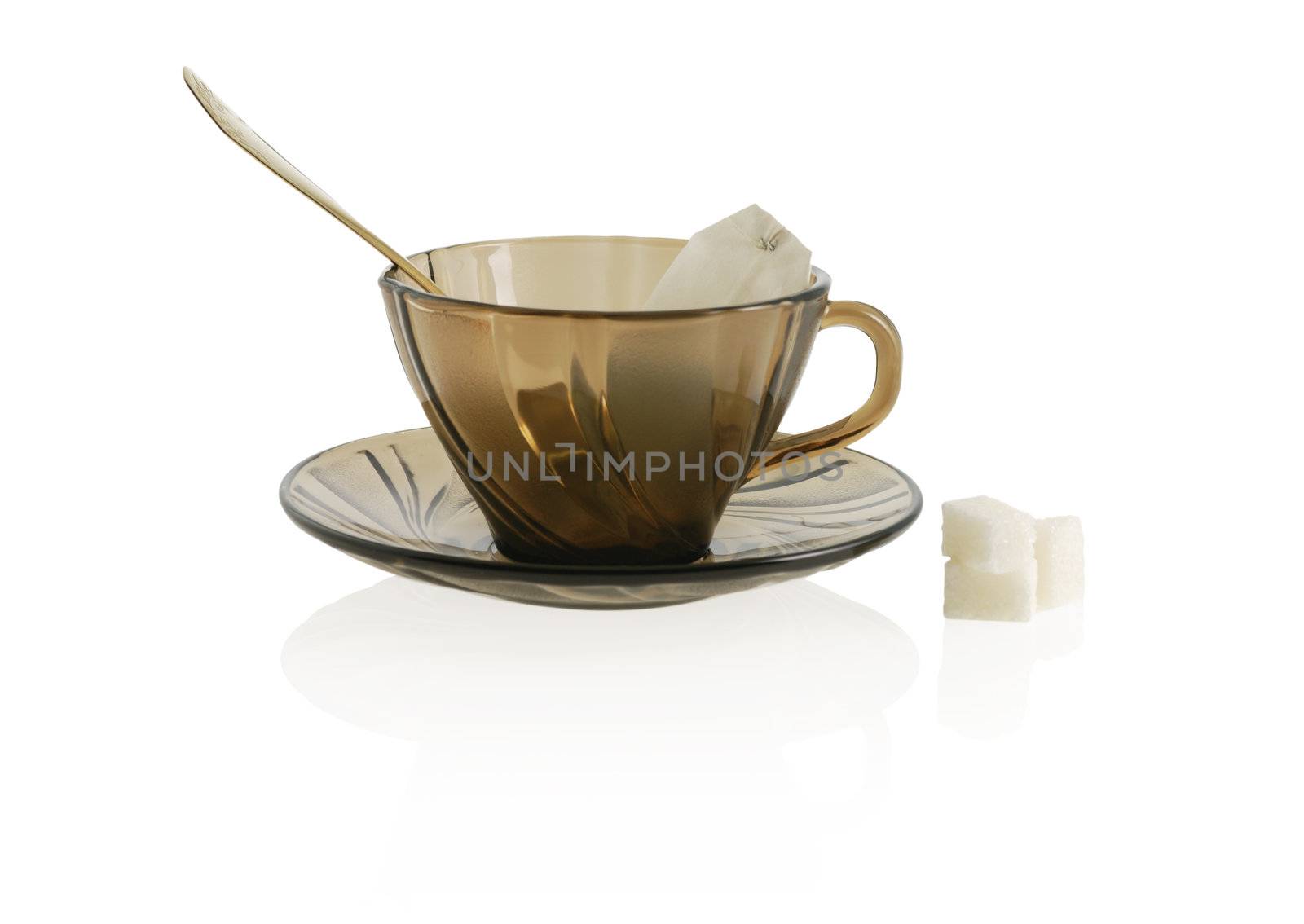 empty glass transparent cup with cookie, sugar anf package tea. Heat-tolerant utensils 