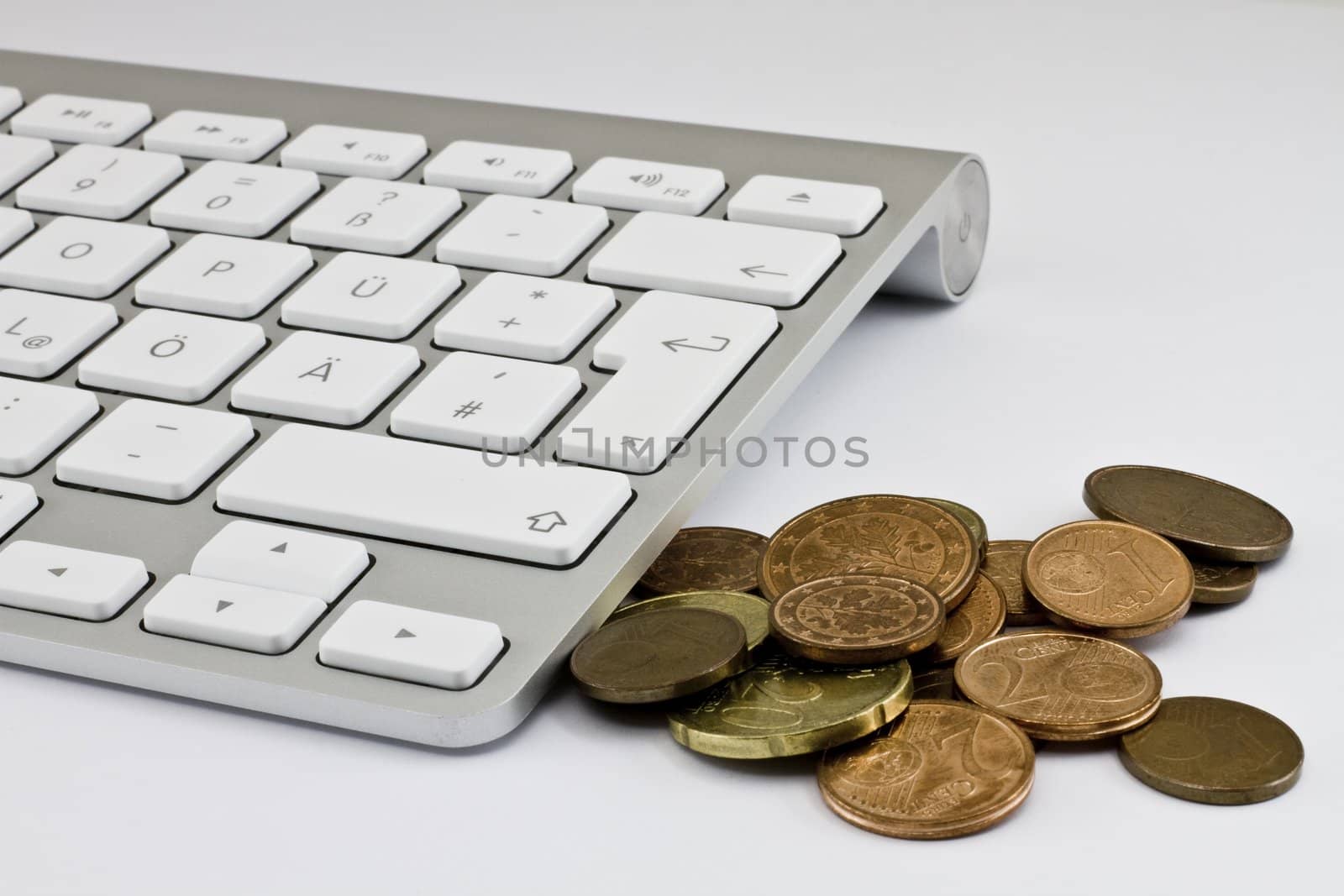 Computer keyboard with white keys and coins