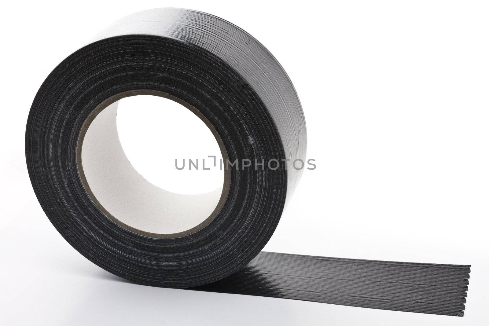 black adhesive tape  on light background. partly unroled