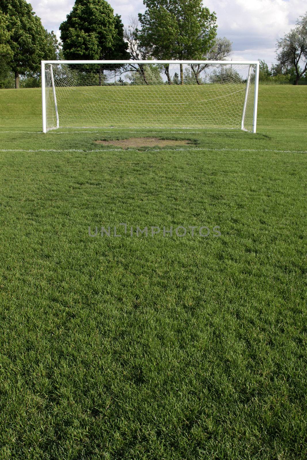 A view of a net on a vacant soccer pitch.
