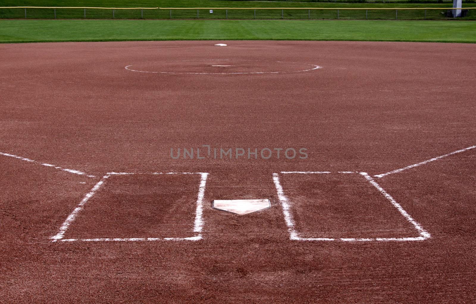 The view from behind the plate on a vacant softball field.