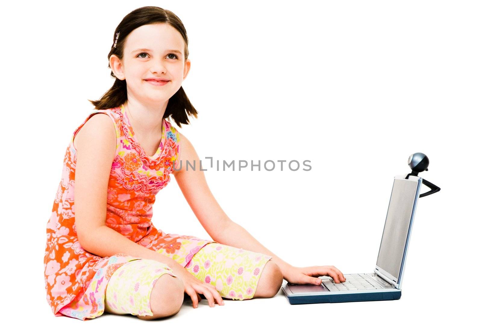 Thinking girl using a laptop and posing isolated over white